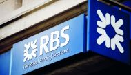 In this file photo taken on October 22, 2017 signage is seen at the front of a branch of the Royal Bank of Scotland in central London. AFP / Tolga Akmen