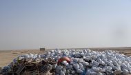 Garbages collected by workers are seen piled up at a spot for disposal. 