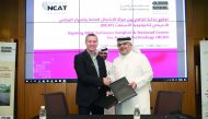 Eng. Saad bin Ahmed Al Muhannadi, President of Ashghal, exchanging documents with an official from the American National Center for Asphalt Technology after signing the MoU during the Fourth Road Workshop entitled “Recycling in Road Projects” at its headq