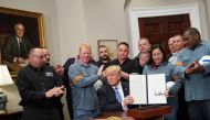 US President Donald Trump shows his signature on Section 232 Proclamations on Steel and Aluminum Imports in the Oval Office of the White House on March 8, 2018, in Washington, DC. / AFP / MANDEL NGAN 