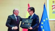 Spain's new Economy Minister Roman Escolano (R) and his predecessor Luis de Guindos smile during a taking over ceremony at Economy Ministry in Madrid, Spain, March 9, 2018. Reuters/Sergio Perez