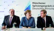 President of the German Confederation of Skilled Crafts (ZDH), Hans Peter Wollseifer, German chancellor Angela Merkel and head of the Confederation of German Employers' Associations (BDA), Ingo Kramer attend German economy summit talks in Munich on March 