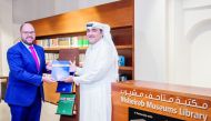 Ryan Gliha (left), Charge  d’Affaires of the US Embassy, presenting the report to the Director of Msheireb Museums, Hafiz Ali. 