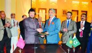 Mohammad Idrees Anwar (left), President of Pakistan Business Forum Doha; and Zahid Latif Khan, President of Rawalpindi Chamber of Commerce & Industry; shake hands after signing of a formal MoU for mutual cooperation and promoting bilateral trade, investme