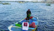 A beneficiary with his boat in Gaza provided by QC under income generating project.