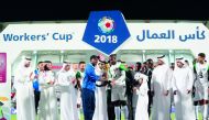 Al Nakheel Landscapes team captain receiving the 2018 Workers’ Cup Trophy during the presentation ceremony at Al Duhail Stadium, yesterday. 