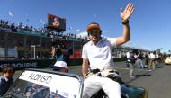 McLaren's Spanish driver Fernando Alonso waves to the crowd during the Drivers' Parade at the Albert Park circuit in Melbourne on March 25, 2018, ahead of the Formula One Australian Grand Prix.
