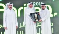 Minister of Municipality and Environment H E Mohamed bin Abdullah Al Rumaihi (centre) honouring Ramez Al Khayyat, Vice-Chairman of the Board of Directors of Baladna, at a ceremony held on the sidelines of  AgriteQ 2018.