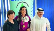 Gold medallist at the Arab Indoor Rowing Championship, Qatar’s rising star Tala Abu Jabara (centre) poses for a photograph with the President of Qatar Sailing and Kayaking Federation (QSKF), Abdullah Al Sulaiti (right) during a welcoming ceremony at the Q
