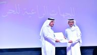Minister of Culture and Sport H E Salah bin Ghanem Al Ali honouring Moutaz Al Khayyat, Chairman of the Board of Directors of Baladna Food Industries.