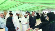 Yousef Al Khulaifi (third left), Director of Agricultural Affairs Department and Abdul Rahman Al Sulaiti (second left), General Supervisor, Farmers’ Markets, at a stall in the Healthy Food Festival at Al Mazrouha Farmers’ Market, yesterday. 