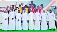 Podium winners of the inaugural Emir’s Beach Volleyball Cup pose for a photograph with Secretary-General of the Qatar Olympic Committee (QOC), Jassim Rashid Al Buenain and other officials during the presentation ceremony.  