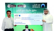 Ahlibank’s Deputy CEO (Retail and Private Banking), Hassan Al Efrangi, presenting the prize money cheque to Al Rabeh winner Shahin Bashi Khajeh. 
