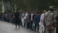 Pakistani spectators stand in a queue before entering the National Cricket Stadium to watch the third and final Twenty20 (T20) International cricket match between Pakistan and West Indies, in Karachi on April 3, 2018. / AFP / ASIF HASSAN