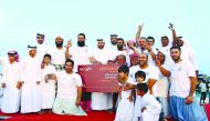 Katara General Manager Dr Khalid bin Ibrahim Al Sulaiti (centre), with the winners of the pearl diving championship, which is part of Katara’s annual Senyar Festival 2018, at Katara beach, yesterday.
