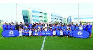 Officials from Qatar Football Association (QFA), Chelsea Foundation and Yokohama Tyres pose for a photograph with participants of the coaching clinic conducted by the QFA Football Development Department and Chelsea Foundation.