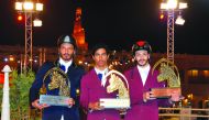 From left: Podium winners of the Small Tour, Saeed Nasser Al Qadi, Ghanim Nasser Al Qadi and Hamad Nasser Al Qadi pose for a photograph with their trophies at the Souq Waqif Arena yesterday. 