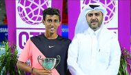 Qatar’s Rashid Nawaf, winner of the Qatar Asian Junior Tennis Tournament, poses for a picture with Qatar Tennis, Squash and Badminton Federation General Secretary, Tariq Darwish Zainal in Doha yesterday.