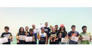 The podium winners of the Swim for a Cause open water swimming challenge, organised by Sharq Village & Spa, at Sharq Village & Spa Beach, pose for a photograph.