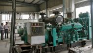 Employees stand next to a power backup generator run by diesel at the Kei Industries, one of India's leading electrical equipment manufacturers at the industrial estate of Bhiwadi, in the western Indian state of Rajasthan August 6, 2012. Reuters/B Mathur