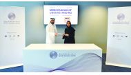 Yousef Abdullah Fakhroo (left), Chief Marketing & Corporate Communications Officer, QFC Authority; and Noura Al Dossari, General Manager, Hasalty, exchange documents after signing the MoU.