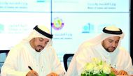 ilal Mohammed Al Khulaifi (left), Director, Legal Affairs Department, Ministry of Economy and Commerce, and  Dr Mohammed bin Abdul Aziz Al Khulaifi, Dean of the College of Law, QU, at the signing ceremony held at the Ministry’s headquarters in Lusail City
