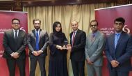 Roya Khajeh (third left), Commercial Bank AGM and Head of Cards and Payments receiving the award from Shahebaz Khan (third right), Visa Country Manager for Qatar, as other officials look on