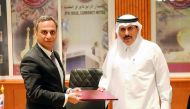 H E Sheikh Abdullah bin Saoud Al Thani (right), QCB Governor, with Ajay Sharma, British Ambassador to Qatar, during the signing ceremony, yesterday. Pic: Abdul Basit/The Peninsula