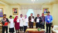 Indonesian Ambassador to Qatar, Muhammad Basri Sidehabi (fourth right), with his family, embassy staff, Chairperson of Overseas Election Committee Doha and members of Committee for Voters Registration for the 2019 General Election, pose during an election