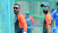 Indian test cricket team captain Ajinkya Rahane (R) and wicket keeper Dinesh Karthik walk together during the team's practice session at the M. Chinnaswamy Stadium in Bangalore on June 13, 2018, on the eve of their one off test match against Afghanistan. 