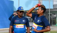 Suranga Lakmal (R) of Sri Lanka takes part in a training session under the watchful eye of Rumesh Ratnayake (L) one day before the 3rd Test between West Indies and Sri Lanka at Kensington Oval, Bridgetown, Barbados, on June 22, 2018. / AFP / Randy Brooks
