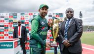 Pakistan captain Sarfraz Ahmed (L) holds the series trophy after victory during the final of the tri-series played between Pakistan and Australia in a T20 tri-series at the Harare Sports Club, July 8 2018. (AFP / Jekesai NJIKIZANA)