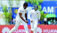 Sri Lanka's Dilruwan Perera (L) celebrates after dismissing South Africa's Quinton de Kock (not pictured) during the second day of the opening Test match between Sri Lanka and South Africa at the Galle International Cricket Stadium in Galle on July 13, 20