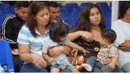 In this file photo taken on June 15, 2018 mothers and children wait to be assisted by volunteers in a humanitarian center in the border town of McAllen, Texas.  (AFP / Leila Macor) 