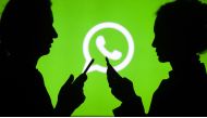 Silhouettes of people holding mobile phones in front of the logo of WhatsApp application in Ankara, Turkey on July 18, 2018. ( Aytaç Ünal - Anadolu Agency )