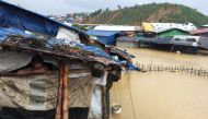 Abdul Hakim (L), a Rohingya refugee man looks on as his shelter gets flooded after heavy rain in Cox’s Bazar, Bangladesh July 25, 2018. Reuters/Clare Baldwin