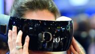 A woman uses a Dior virtual reality mask at the French multinational luxury goods group LVMH exhibition stand during the Vivatech fair ( (Viva Technology) in Paris. 