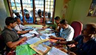  People wait to check their names on the draft list at the National Register of Citizens (NRC) centre at a village in Nagaon district, Assam state, India, July 30, 2018. Reuters