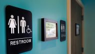 Unisex signs hanging outside bathrooms at Toast Paninoteca in Durham, North Carolina, May 9, 2016.  AFP/Getty Images North America/Sara D Davis