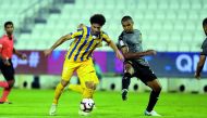 Al Gharafa’s Ahmed Alaaeldin Abdlmotaal (left) and Sandro Ferreira Nascimento of Qatar SC vie for the ball possession during their QNB Stars League (QSL) match at Al Sadd Stadium yesterday. 
Pic: Abdul Basit/The Peninsula
