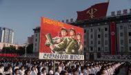 People attend a rally in support of North Korean stance against the US on Kim Il-Sung square in Pyongyang on August 9, 2017.  Nearly half of North Korea's population - 10 million people - are undernourished, according to UN officials, who have reported a 