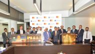 Dr Seetharaman (centre), Group CEO, Doha Bank; Khalid Elgibali (seventh right), Division President, Middle East and North Africa, at Mastercard, cut a cake to mark the launch of a suite of new debit card products with innovative value-added services for i