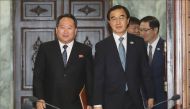 South Korean Unification Minister Cho Myoung-gyun (2nd L) and his North Korean counterpart Ri Son Gwon (L) walk into a meeting room for their talks at the northern side of the border truce village of Panmunjom in the Demilitarized Zone (DMZ) dividing the 
