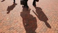 Attorneys for former Trump campaign chairman Paul Manafort, cast long shadows as they arrive at the Albert V. Bryan U.S. Courthouse for the eleventh day of Manafort's trial August 14, 2018 in Alexandria, Virginia. Chip Somodevilla/Getty Images/AFP 