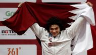 Silver medalist Fares Elbakh of Qatar celebrates on the podium. REUTERS/Beawiharta