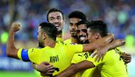 Al Sadd players celebrate after scoring a goal against Esteghlal  during their AFC Champions League quarter-final (first leg) at the Azadi Stadium in Tehran, yesterday. 