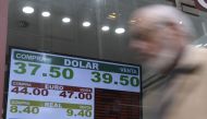 Currency exchange values are displayed in the buy-sell board of a bureau de exchange in Buenos Aires, on September 3, 2018.  AFP / Juan Mabromata
