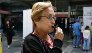 A woman tries a whistle at the Pantitlan Metro Station in Mexico City during a campaign aimed at preventing sexual abuse on July 06, 2016. AFP/Alfredo Estrella