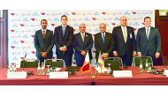 H E Jassim bin Saif Al Sulaiti (third left), Minister of Transport and Communications; Hassan Al Ibrahim (third right), QTA’s Acting Chairman, and Rashed Al Qurese (left), Chief Marketing and Promotion Officer at QTA, with other officials during the signi
