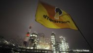 A flag with the logo of Rosneft, Russias largest oil company, flutters over the Novokuibyshevsk refinery near the city of Samara, October 28, 2010. Reuters/Nikolay Korchekov